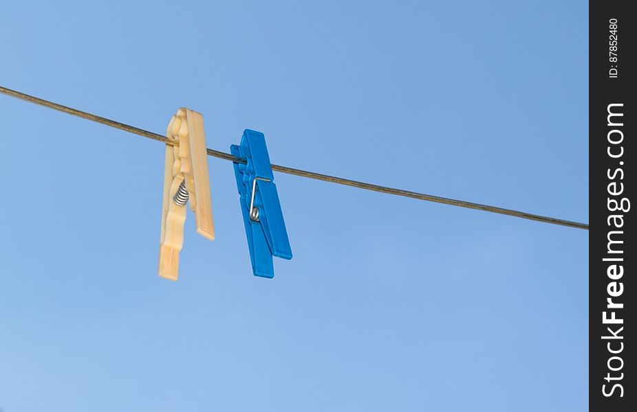 blue-and-yellow-pegs-on-clothes-line