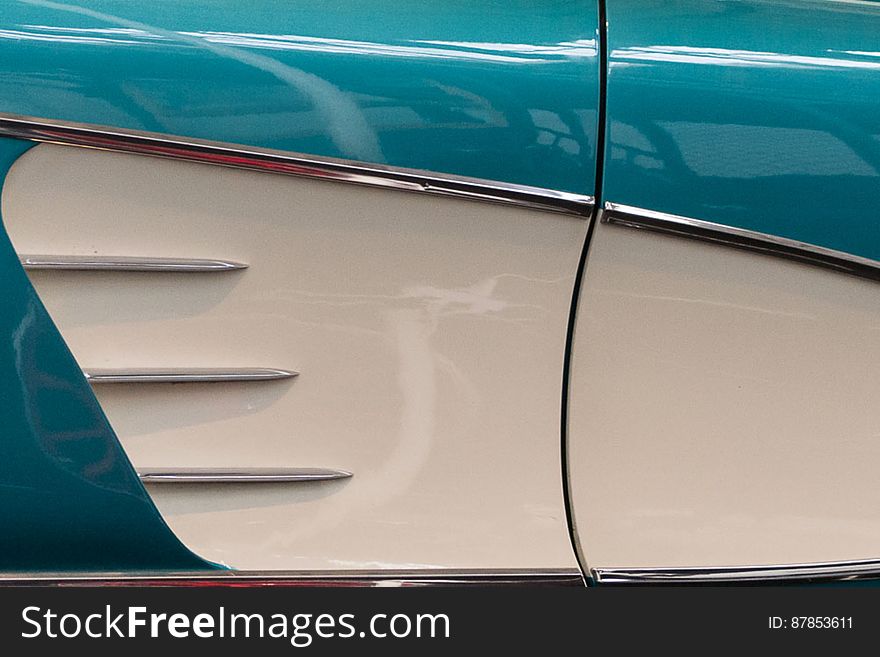 Chrome ornaments on side panel of a classic Chevrolet Corvette C1 American car. Chrome ornaments on side panel of a classic Chevrolet Corvette C1 American car.