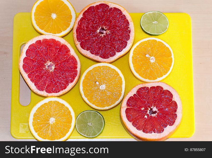 Limes, grapefruits and oranges cut in halves on kitchen board, ready to be squeezed for fresh juice.