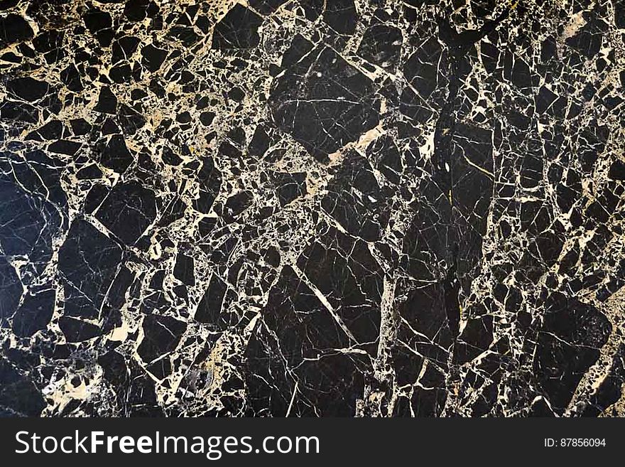 Polished table top made of Chinese black marble with white veins.