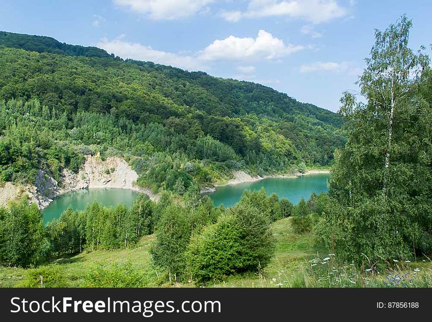 Reservoir with clear emerald water in a pitoresque location in the mountains. Reservoir with clear emerald water in a pitoresque location in the mountains.