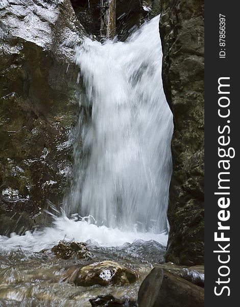 Forest waterfall blurred in slow motion capture.