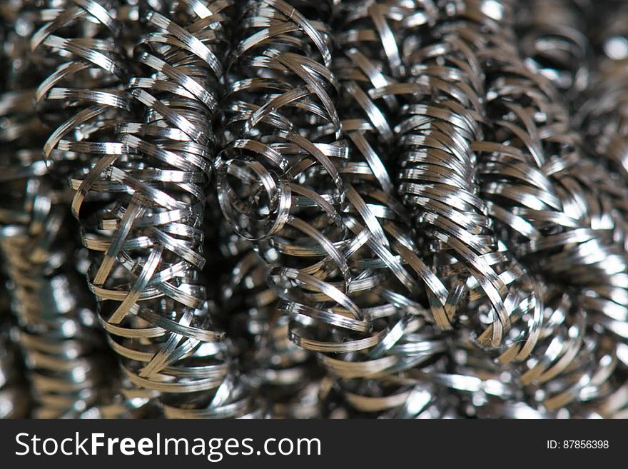 Close-up of a cleaning scrub metallic spirals used for doing dishes. Close-up of a cleaning scrub metallic spirals used for doing dishes.