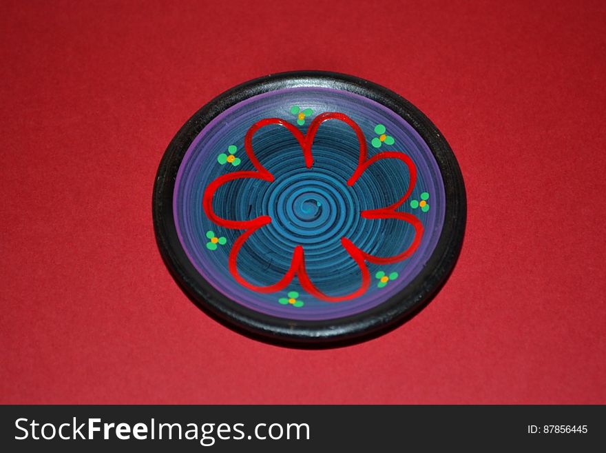 miniature-ceramic-plate-isolated-on-red
