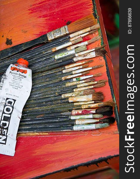 Painting brushes of different sizes used by artist with dried out acrylic paint on bristles. Painting brushes of different sizes used by artist with dried out acrylic paint on bristles.