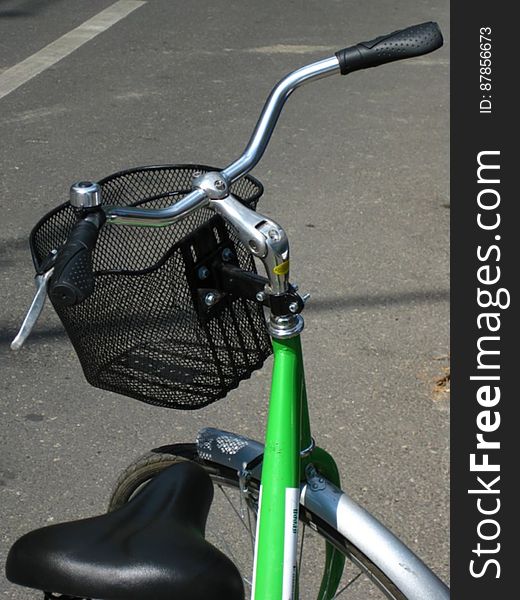 parked-green-bicycle-with-basket