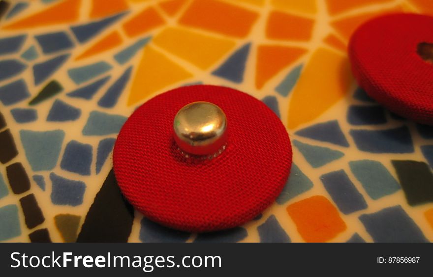 red-button-on-ceramic