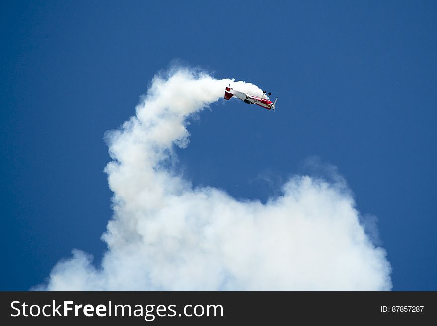 A Russian Sukhoi Su-31 Aerobatics Aircraft Performing An Inside Loop While Leaving Smoke Traces.