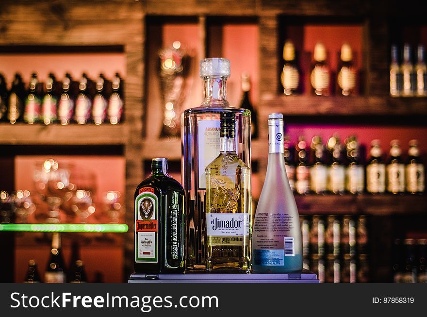A bar with various bottles of alcoholic drinks. A bar with various bottles of alcoholic drinks.