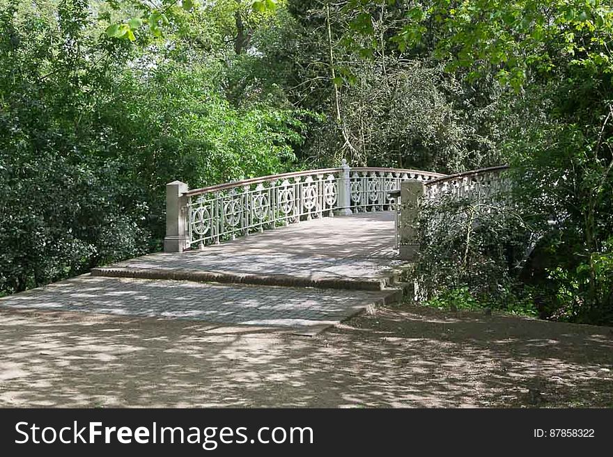 Humpback bridge wooden walkway on metallic structure in a city park. Humpback bridge wooden walkway on metallic structure in a city park