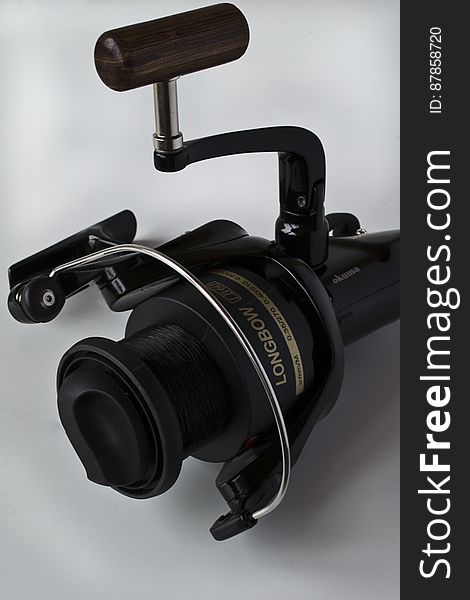 A fishing spinning reel displaying line on spool.