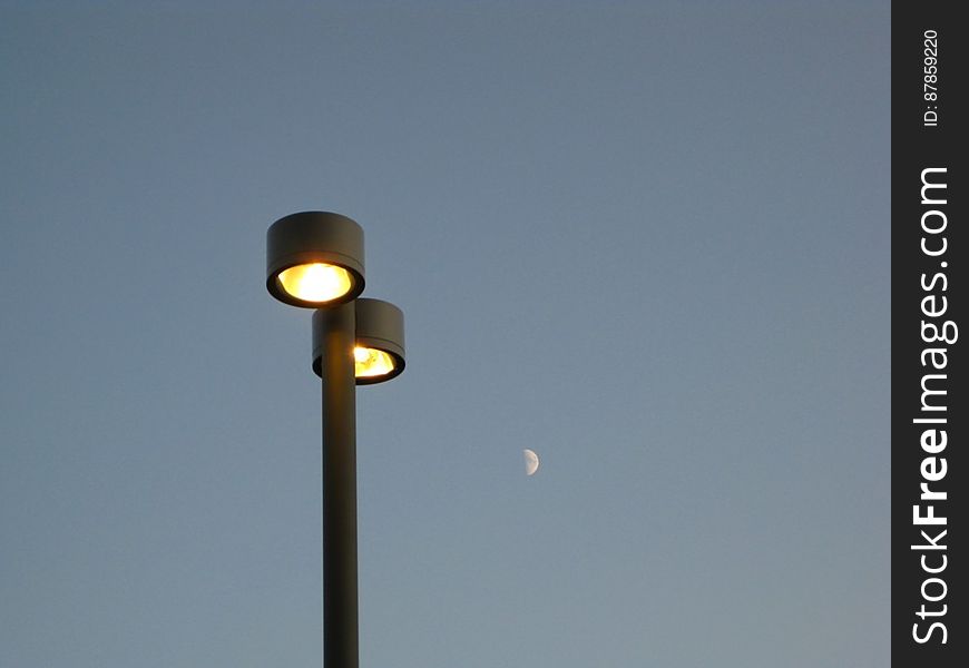 twin-lamp-post-and-half-moon-in-the-background