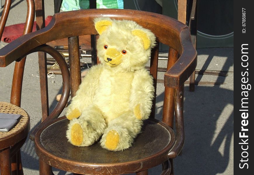 yellow-teddy-bear-on-chair