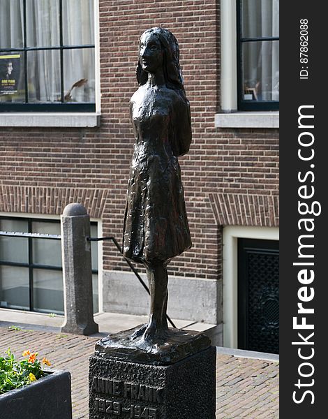 Statue of famous Jewish young diarist Annelies Marie &#x22;Anne&#x22; Frank, victim of the Holocaust after hiding with her familiy in an Amsterdam building annex &#x28;Achterh. Statue of famous Jewish young diarist Annelies Marie &#x22;Anne&#x22; Frank, victim of the Holocaust after hiding with her familiy in an Amsterdam building annex &#x28;Achterh