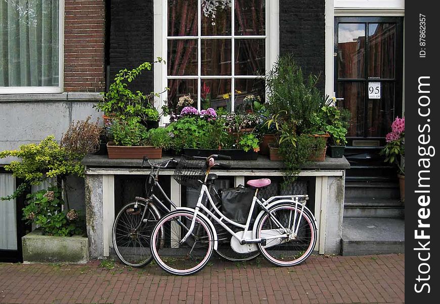 Bicycles Parked In Front Of Canal House