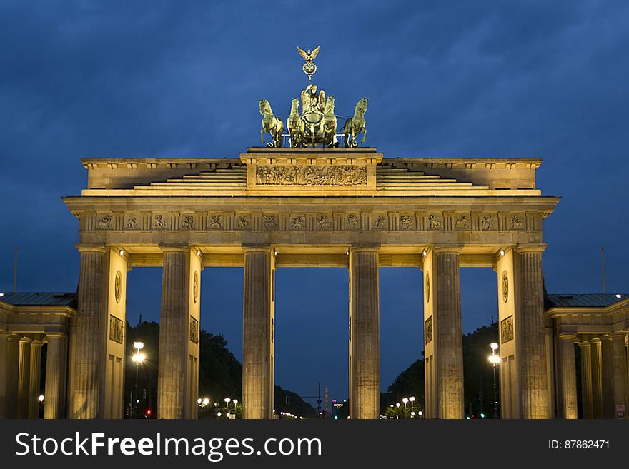 Brandenburg Gate is a former Berlin city gate inspired by the greek Propylea hall, with doric columns and quadriga depicting Victoria riding a four hourse chari