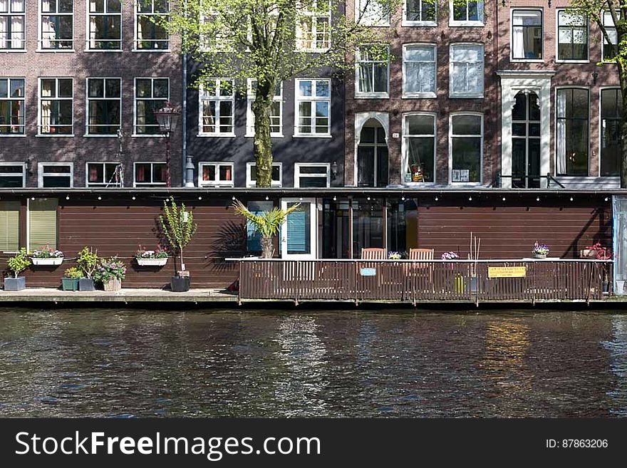 A water home unlike the more common houseboats on a quiet Jordaan district canal in Amsterdam. A water home unlike the more common houseboats on a quiet Jordaan district canal in Amsterdam