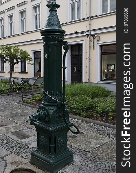 Manual water pump decorated with a dragon&#039;s head in Berlin&#039;s old quarter Nikolaiviertel.