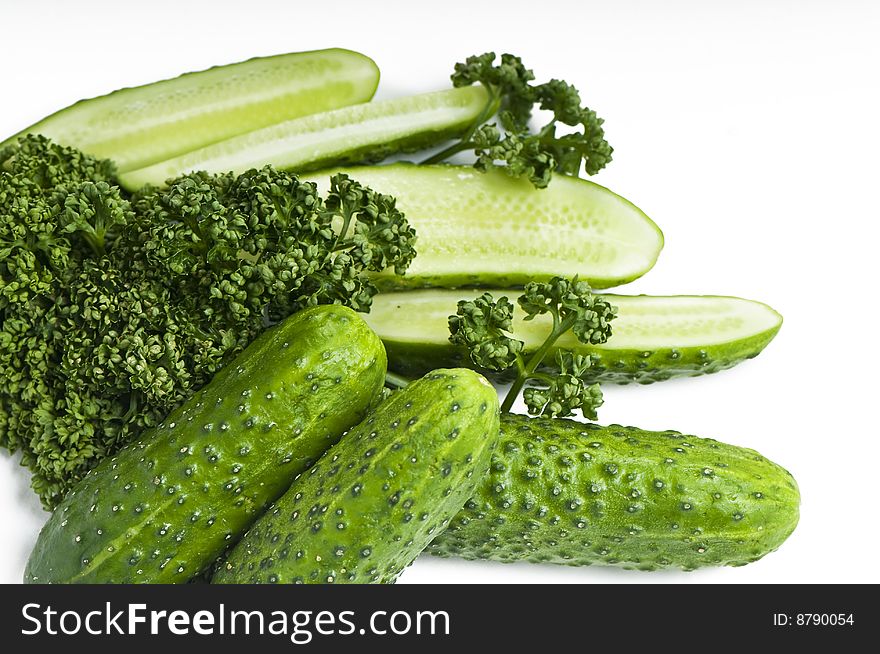Cutted and whole  cucumbers and parsley, healthy food isolated on white