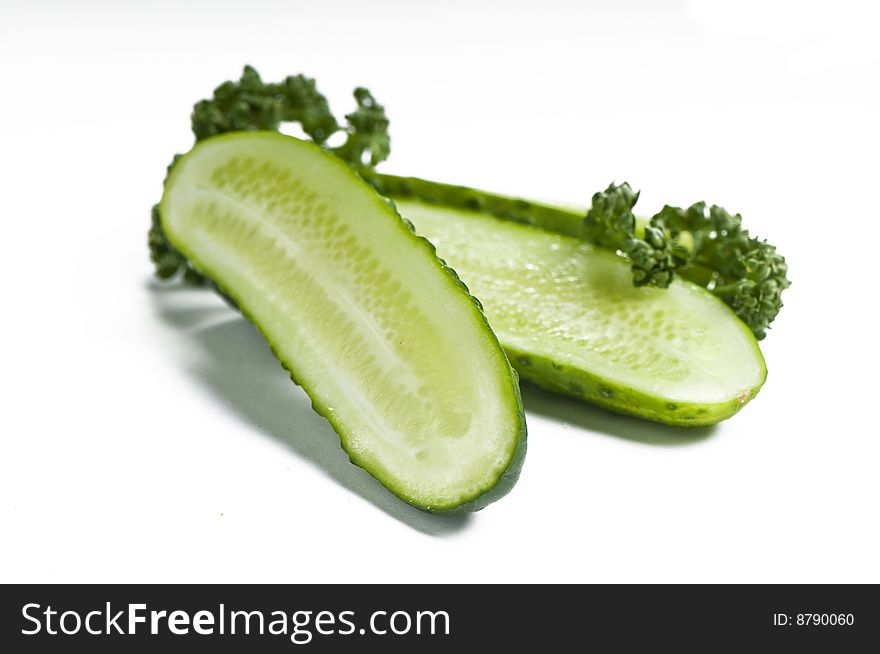 Cutted cucumbers and parsley, healthy food isolated on white