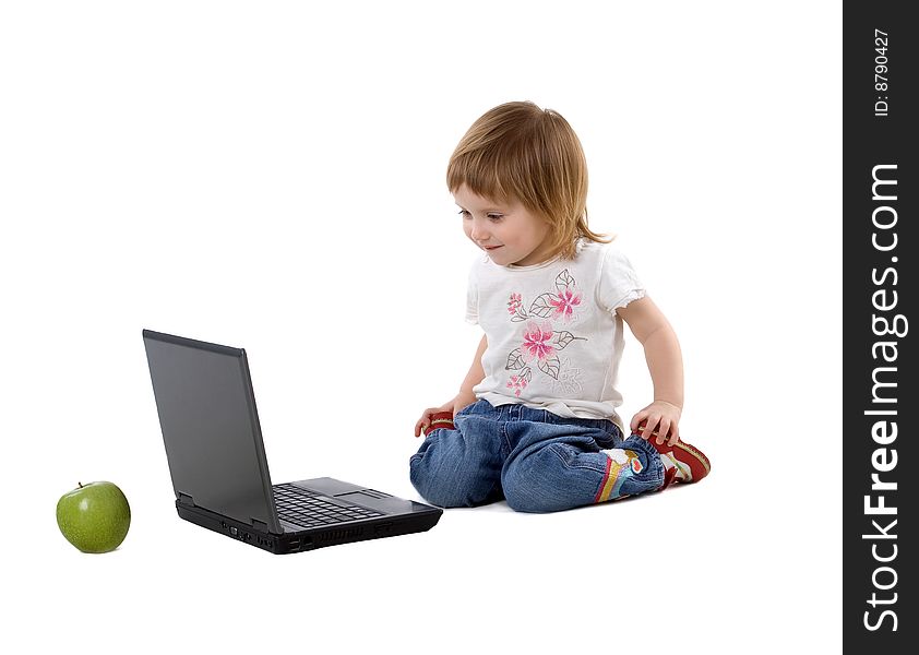 Cute little girl sit near laptop. Studio shot. Cute little girl sit near laptop. Studio shot