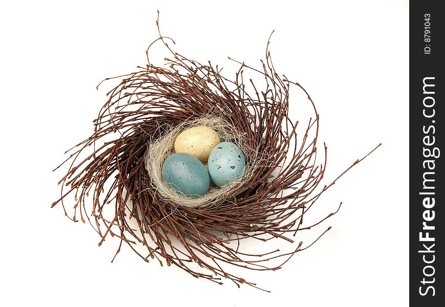 Painted eggs in bird's nest isolated on white background. Painted eggs in bird's nest isolated on white background