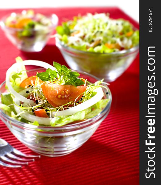 Three bowls fresh salad with tomato onion lettuce
