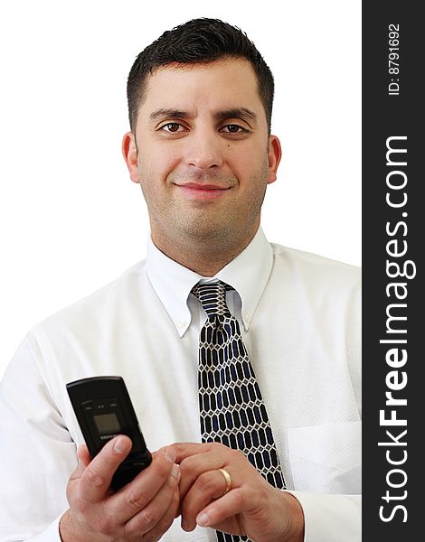 A handsome young businessman smiling and holding his cellphone over white. A handsome young businessman smiling and holding his cellphone over white