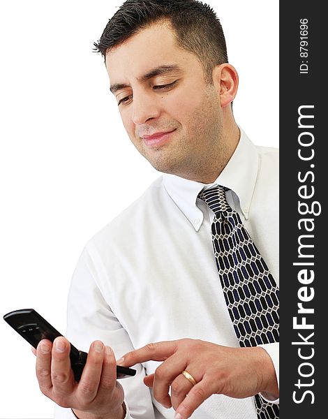 A handsome young businessman smiling and holding his cellphone over white. A handsome young businessman smiling and holding his cellphone over white