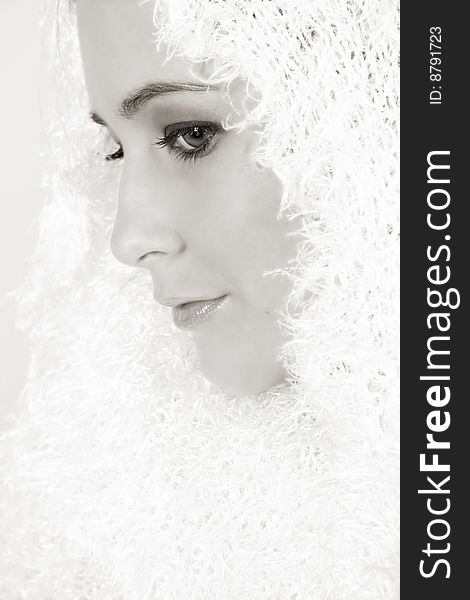 Beautiful young female model wrapped in white wool scarf. Beautiful young female model wrapped in white wool scarf