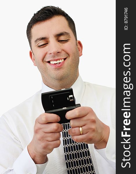 A handsome young businessman texting on his cell phone over white. A handsome young businessman texting on his cell phone over white