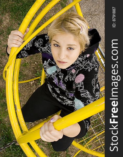 A young girl climbing in the children's playground. A young girl climbing in the children's playground