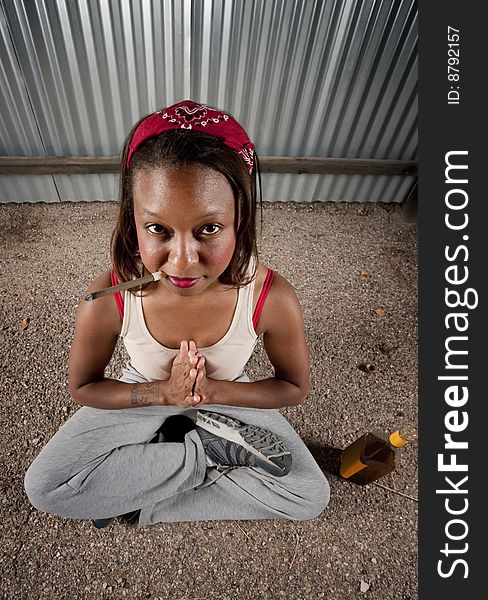 Woman meditating with cigar and tequila bottle. Woman meditating with cigar and tequila bottle