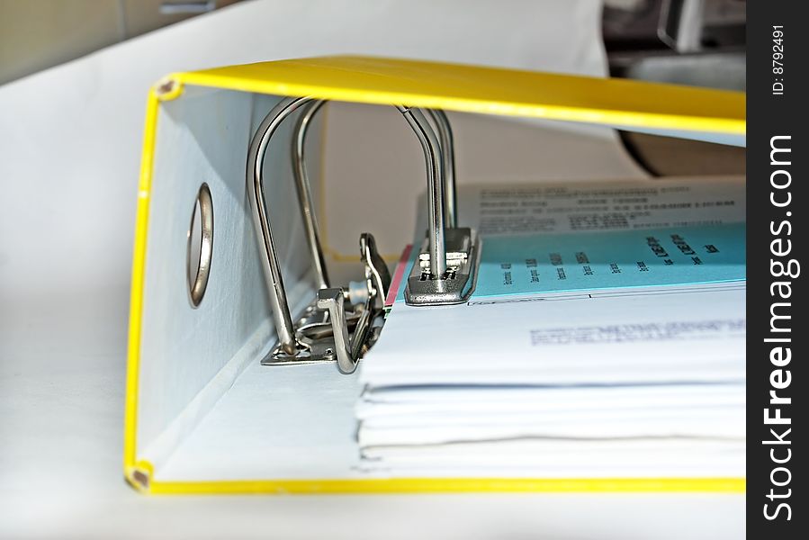 Documents in paper file with metallic lock mechanism. Documents in paper file with metallic lock mechanism