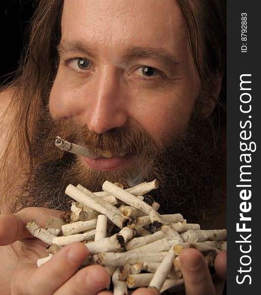 Very Powerful Image of a Man Holding A pile Of Cigarette Butts. Very Powerful Image of a Man Holding A pile Of Cigarette Butts