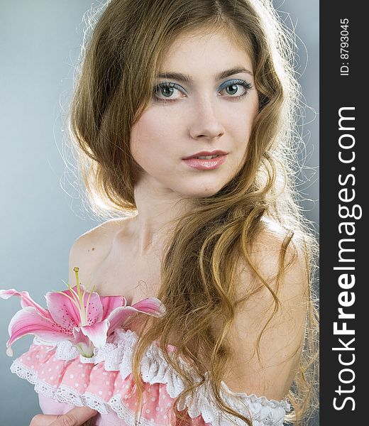 Beautiful young girl with lily flower