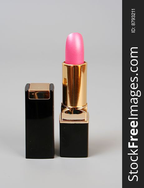 Pink lipstick on a grey background. Pink lipstick on a grey background