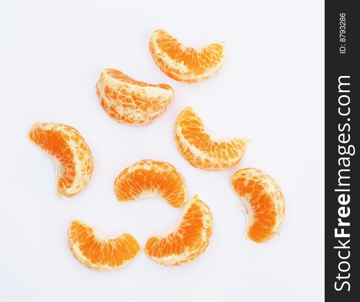 The juicy peeled orange on the white background. The juicy peeled orange on the white background.