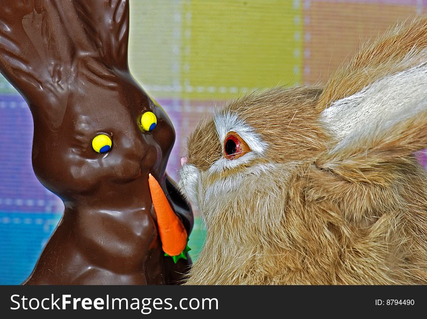 Cute bunny with a chocolate Easter bunny. Cute bunny with a chocolate Easter bunny.