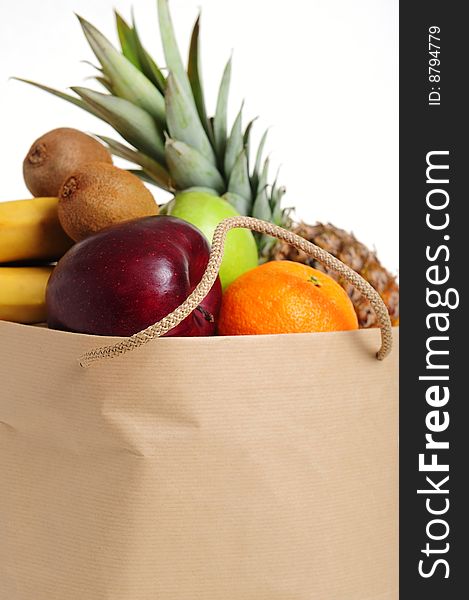 Asorted fruits in shopping bag, white background. Asorted fruits in shopping bag, white background