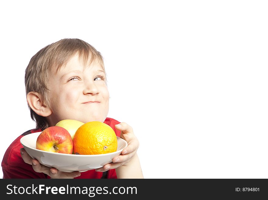 Isolated boy holding plate with fruits over white background. Isolated boy holding plate with fruits over white background