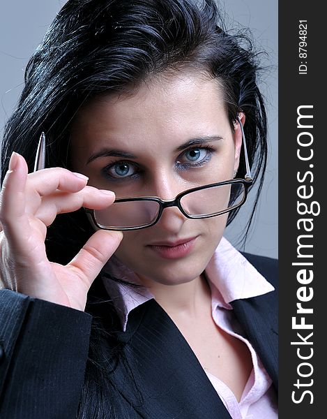 Close up portrait of beautiful business women looking over glasses. Close up portrait of beautiful business women looking over glasses