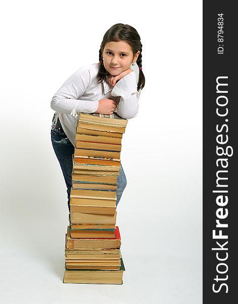 Young girl and a stack of books. Young girl and a stack of books