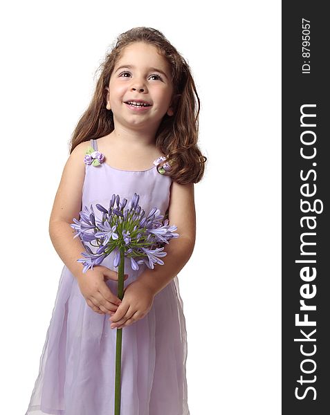 Smiling girl looking up holding a purple agapanthus flower.  Space for your copy. Smiling girl looking up holding a purple agapanthus flower.  Space for your copy.