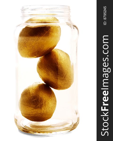 Golden eggs in a jar isolated over white