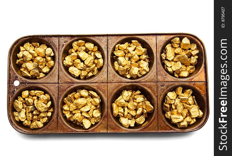 Gold pieces in a serving tray isolated over white