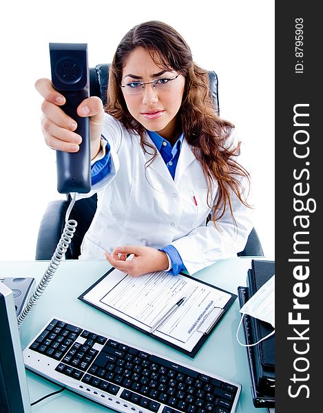 Young female doctor showing phone receiver on an isolated background