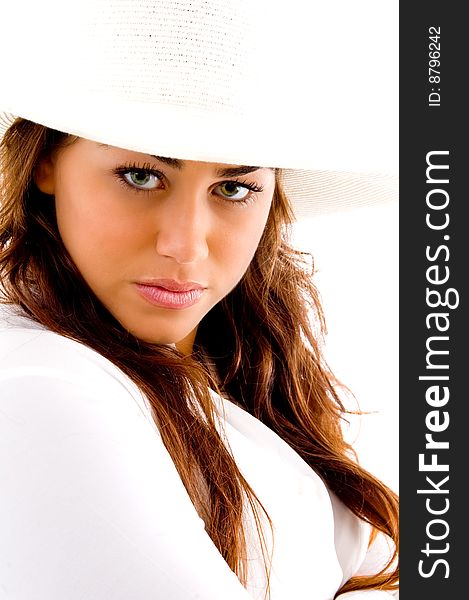 Posing woman with hat and looking at camera against white background