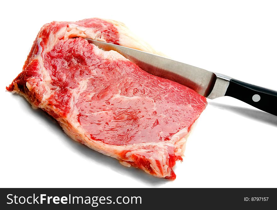 Kitchen knife cutting beef isolated over white