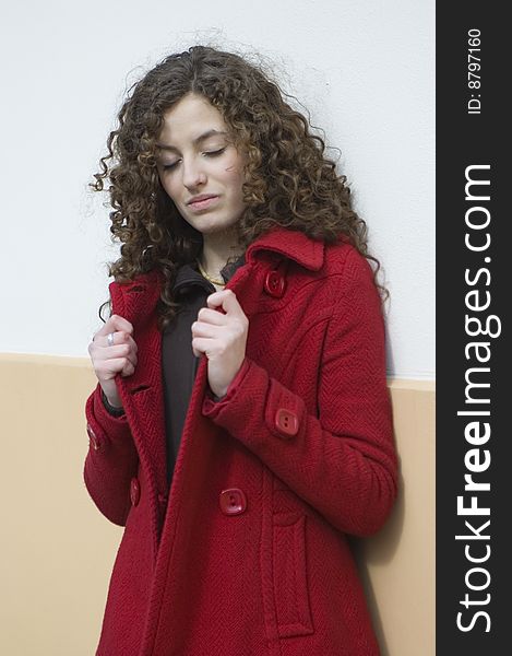 Teenage girl in Poland, portrait. Young girl with curly hairs wearing red coat, posing in Wroclaw city. Teenage girl in Poland, portrait. Young girl with curly hairs wearing red coat, posing in Wroclaw city.